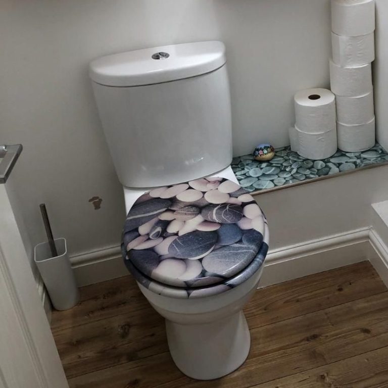 Clean Toilet Decorative toilet seat featuring a design of pebbles in a bathroom setting.