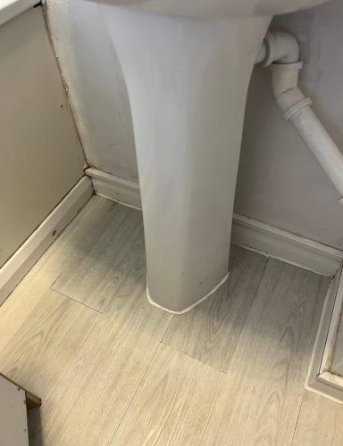 Close-up of a toilet pedestal against a light-coloured floor.